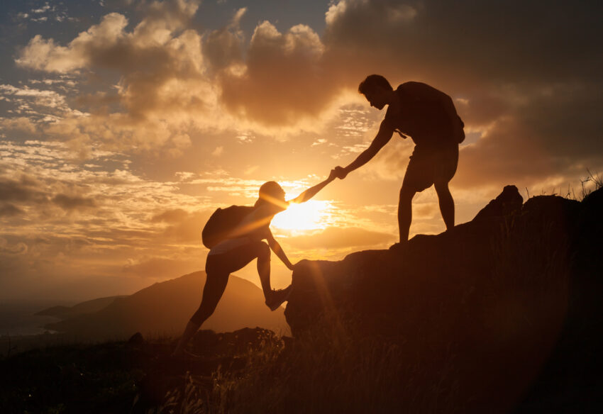 Male,And,Female,Hikers,Climbing,Up,Mountain,Cliff,And,One